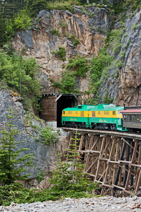 Train on bridge entering tunnel - by Peter Reid