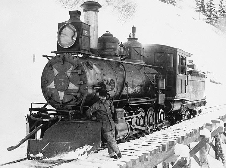 Photo: John Call Benedict, engineer, stops for a photo with Steam Engine No.5 in 1900.
